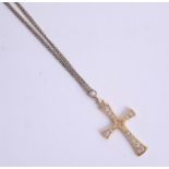 An 18ct gold cross on yellow metal chain, approx. 3.9g.