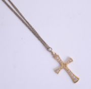 An 18ct gold cross on yellow metal chain, approx. 3.9g.