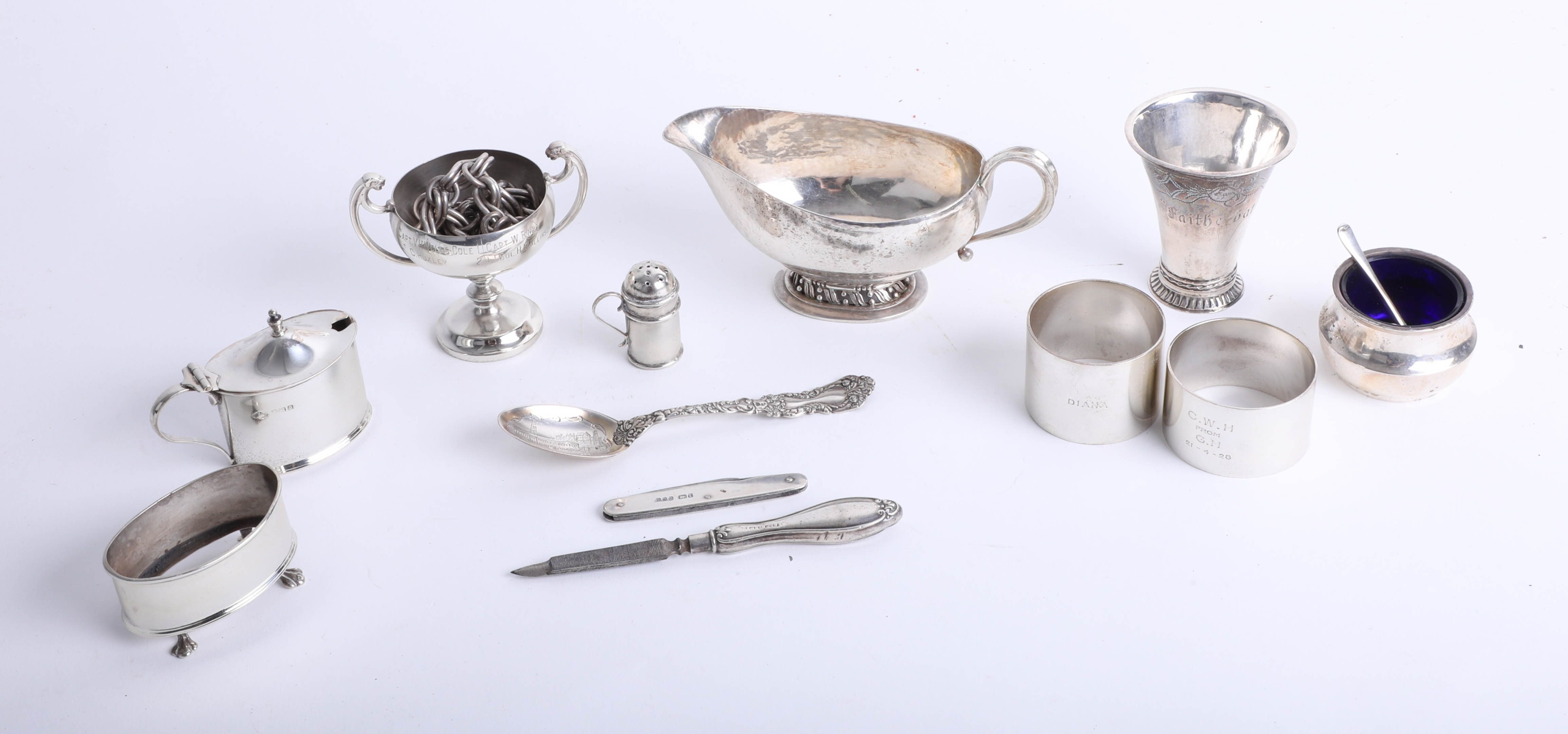 Small collection of silver wares to include napkin rings, sauce boat and 'Faithe Hath No Feare' cup,