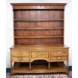 An 18th/19th century welsh oak dresser, in two sections with upper open rack with iron hooks, the