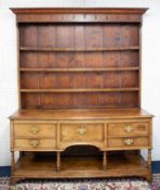 An 18th/19th century welsh oak dresser, in two sections with upper open rack with iron hooks, the