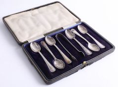Seven piece silver spoon and tong set, cased.