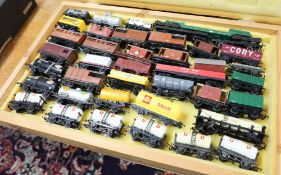 Approximately forty various wagons etc including Triang and Hornby in wood case.