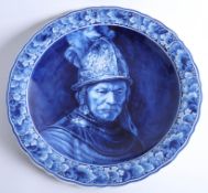 A Delft blue and white charger by Thooft and Labouchere, of 'The man with the golden helmet',