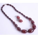 A red amber necklace approx. 32.2g together with earrings.