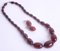 A red amber necklace approx. 32.2g together with earrings.