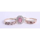 A collection of three dress rings including a pink stone cluster ring, and 9ct garnet set ring. (3).