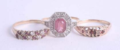 A collection of three dress rings including a pink stone cluster ring, and 9ct garnet set ring. (3).