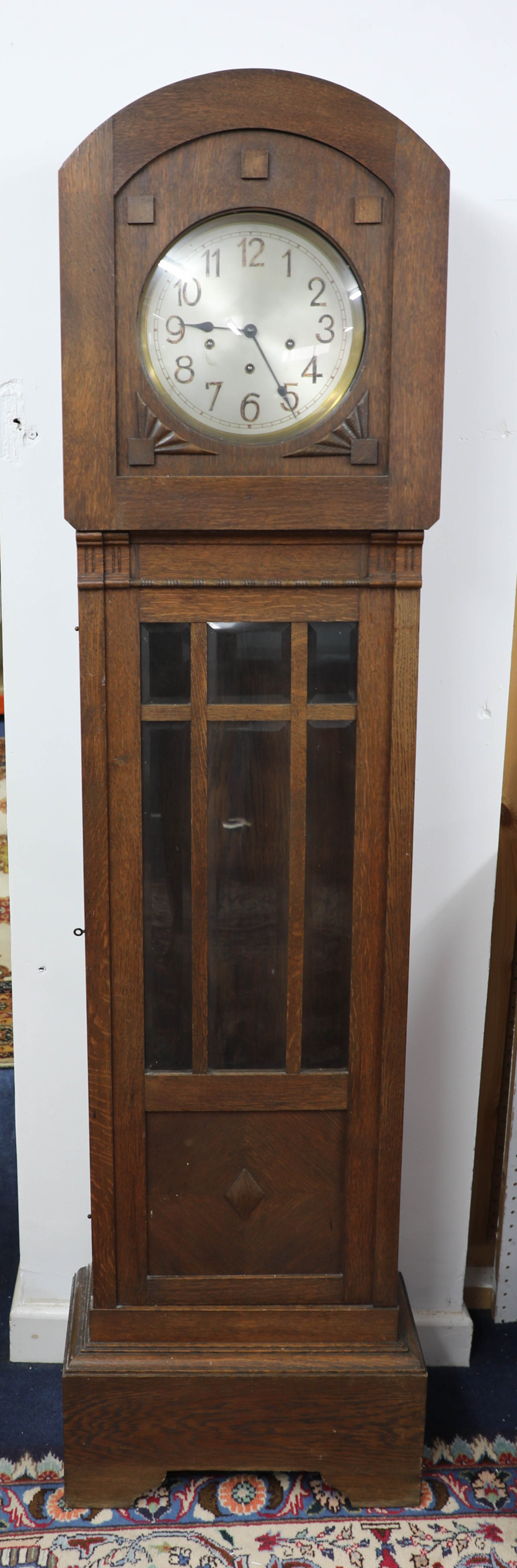 A 1930's oak longcase clock, with chiming movement.