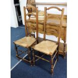 Pair of oak framed ladder back and rush seated side chairs.