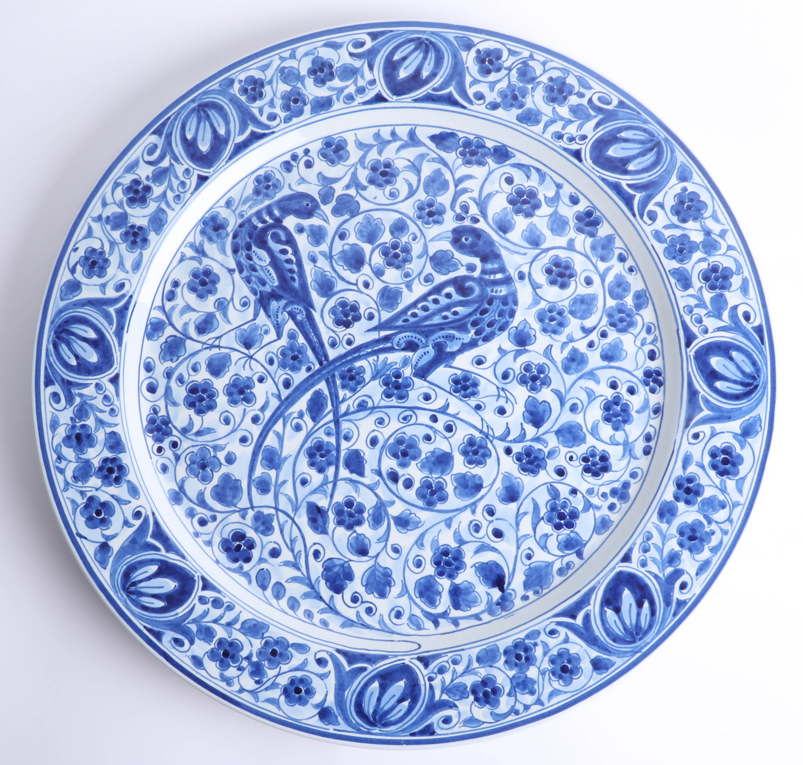 A Delft blue and white charger by Thooft and Labouchere, decorated with a pair of exotic long tailed