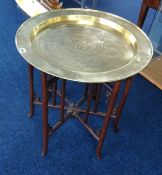 A Chinese brass top table with hardwood folding base.