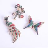 A collection of three modern fashion brooches in the form of a butterfly, peacock and clown.
