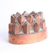 A Victorian copper jelly mould, width 7.5cm.