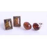 Two pairs of modern amber and silver back earrings.