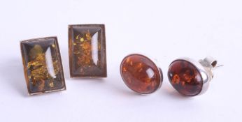 Two pairs of modern amber and silver back earrings.