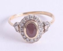 An 18ct yellow gold ruby and diamond halo ring, set with a oval facet cut centre ruby approx. 7.3