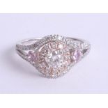 An 18ct diamond and pink sapphire ring, size O.