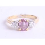 An 18ct pink sapphire and diamond three stone ring, 3.6g, size M.