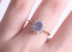 An 18ct sapphire and diamond cluster ring, size N.