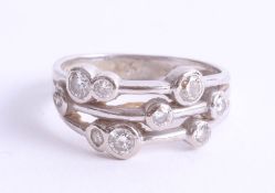 An 18ct white gold Raindance style diamond ring set with nine brilliant round cut diamonds in a