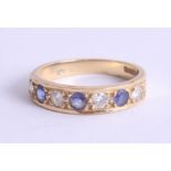 An 18ct sapphire and diamond half band ring set with seven stones, size N.
