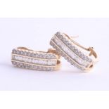 A pair of 14ct gold and diamond set earrings with a combination of round and baguette cut diamonds