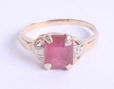 A ruby style and diamond set ring in yellow gold, unmarked, size L.