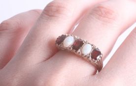 An Edwardian garnet and opal ring, ring size T (no hallmarks).