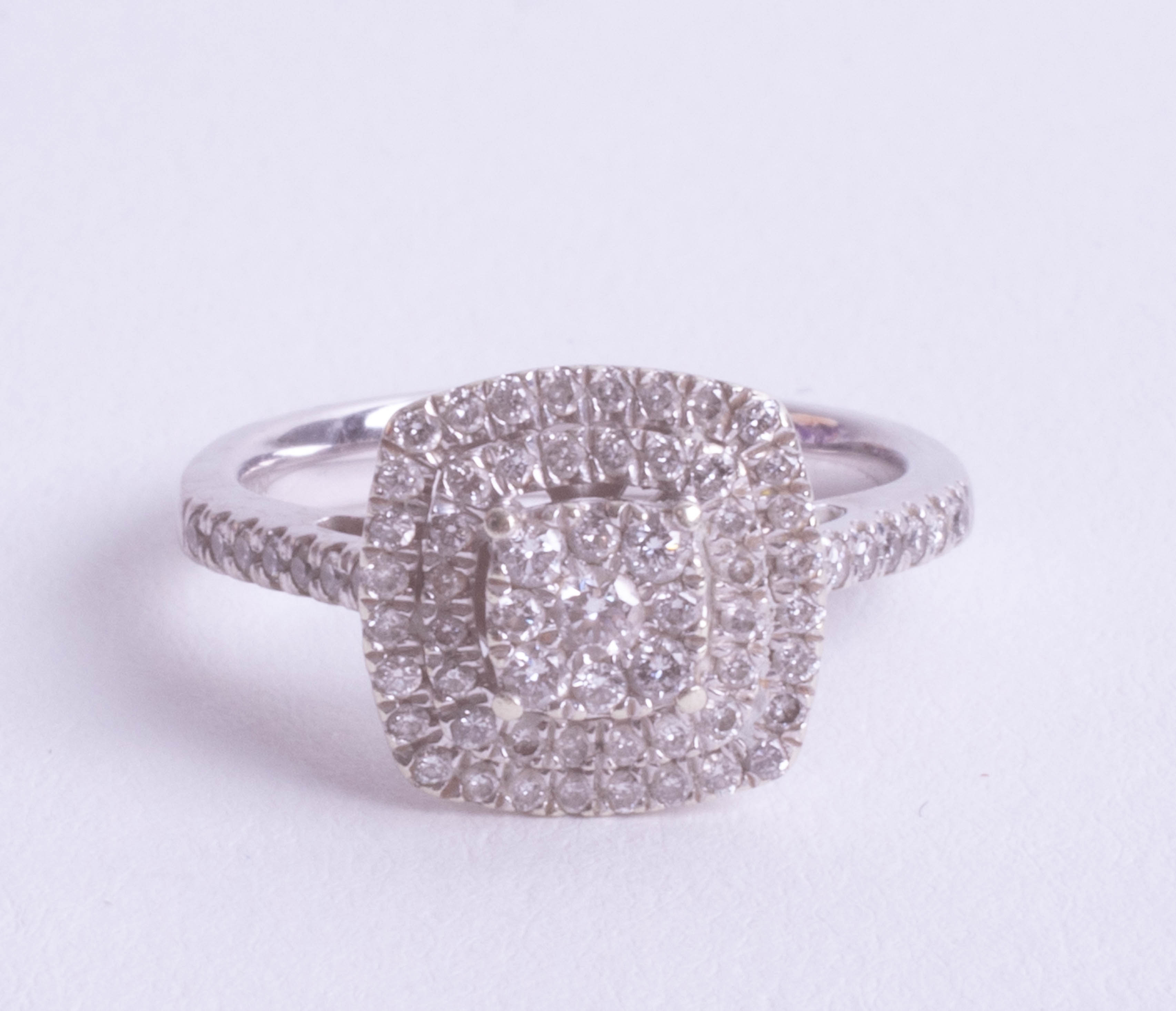 A 9ct white gold and diamond set ring, size L.