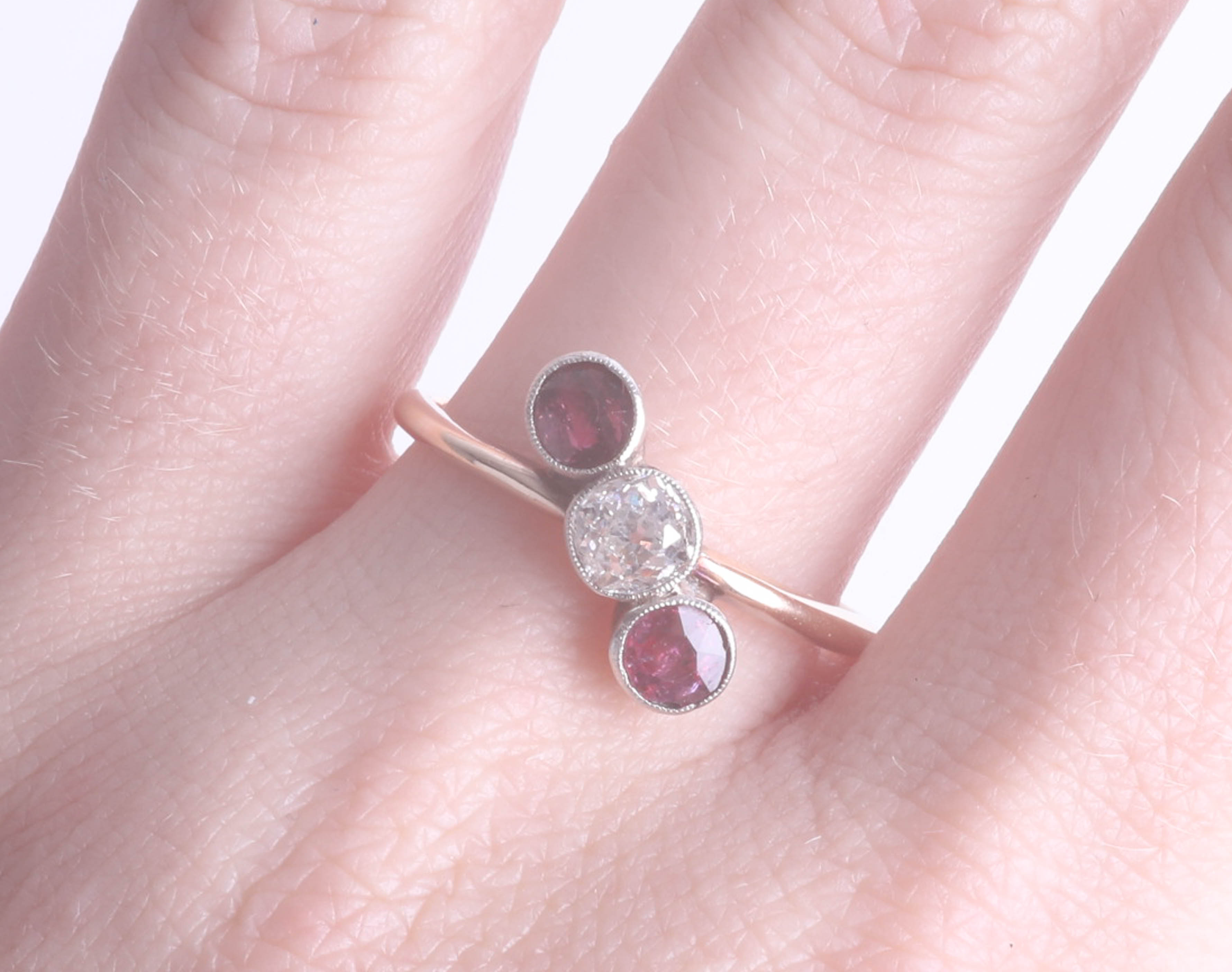 A ruby and diamond three stone ring in unmarked yellow gold, size S. - Image 2 of 2