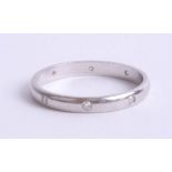 An 18ct white gold and diamond set wedding band, approx 2.9g, size O.