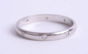 An 18ct white gold and diamond set wedding band, approx 2.9g, size O.