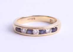 An 18ct yellow gold half band eternity ring, channel set with sapphires and diamonds, size J.