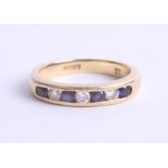 An 18ct yellow gold half band eternity ring, channel set with sapphires and diamonds, size J.