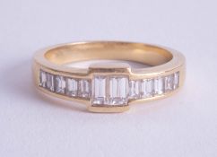 An 18ct yellow gold baguette cut diamond ring, size R.