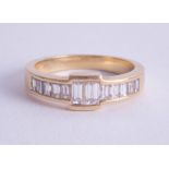 An 18ct yellow gold baguette cut diamond ring, size R.