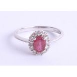 An 18ct white gold ruby cluster ring, size K.