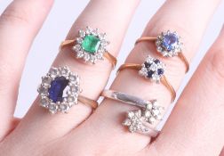 A collection of five various dress rings, including an 18ct emerald and diamond cluster ring, three