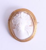 A yellow gold oval cameo brooch with double figures each with vine and grapes hair