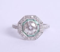 An art deco style diamond and emerald ring set in 18ct white gold, approx 0.95ct, Size M.