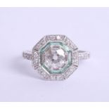 An art deco style diamond and emerald ring set in 18ct white gold, approx 0.95ct, Size M.