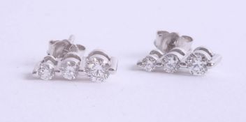 A pair 18ct white gold diamond three stone earrings.