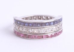A diamond ruby and sapphire night and day ring set in platinum, size L.