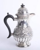 A late Victorian small coffee pot, London Circa 1894 marked GMJ with embossed and fluted decoration,