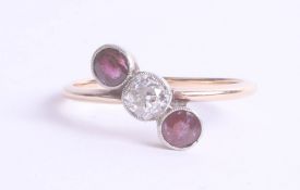 A ruby and diamond three stone ring in unmarked yellow gold, size S.