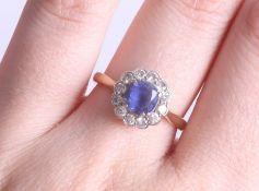 An 18ct round sapphire and diamond cluster ring, size O.