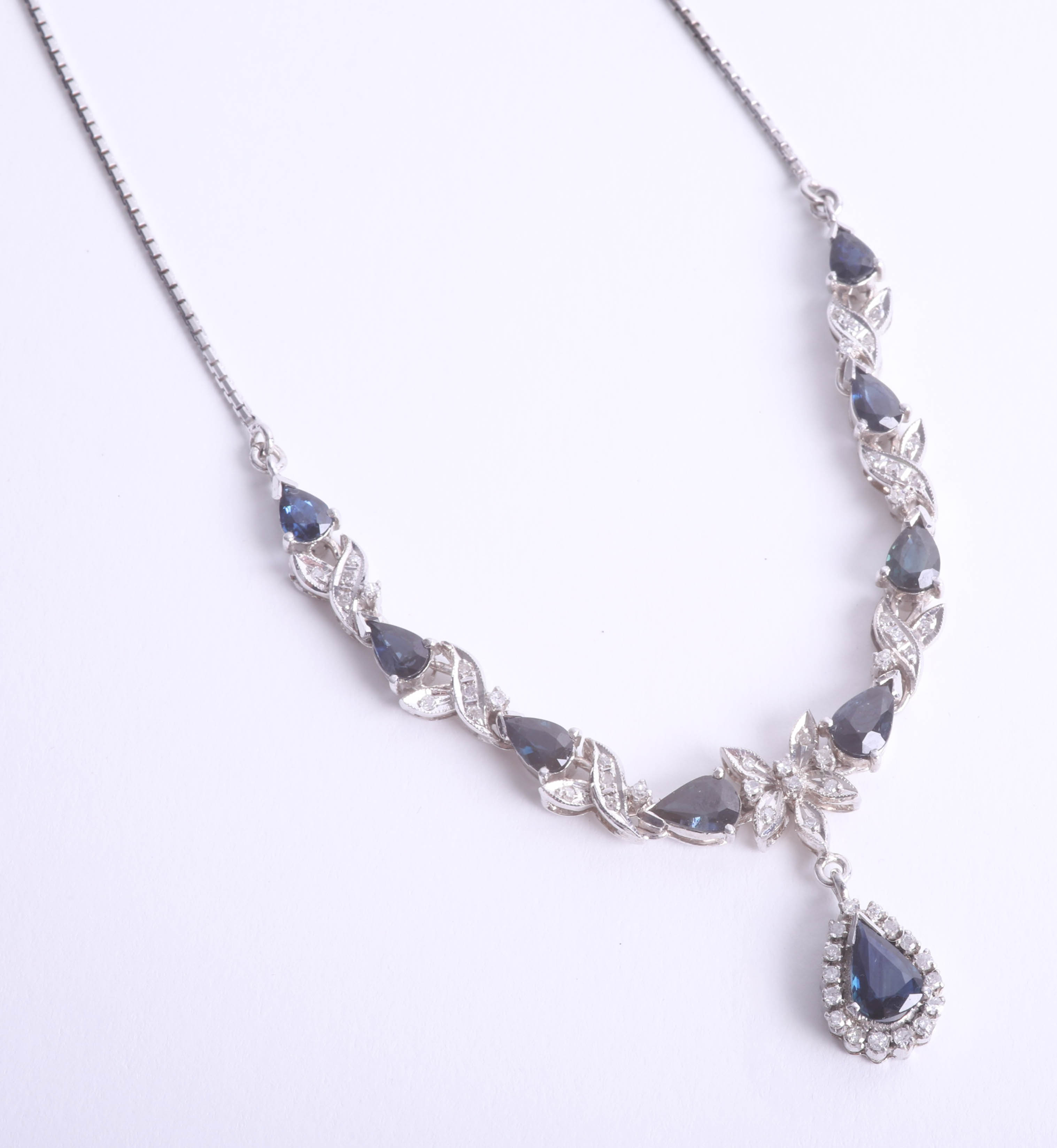 An 18ct white gold necklace set with diamonds and sapphires with drop pendant, length of main