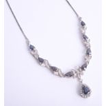 An 18ct white gold necklace set with diamonds and sapphires with drop pendant, length of main