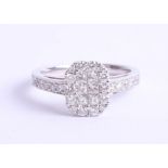 An 18ct diamond set ring, pave set with six princess cut diamonds within a border of thirteen